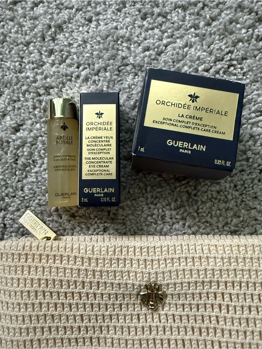 GUERLAIN gold and cream skincare set with woven clutch